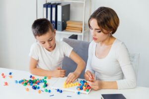 Female BCBA providing autism therapy for kid