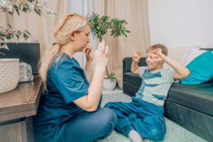 Child with autism demonstrating hand posturing behaviors while sitting calmly in a supportive environment